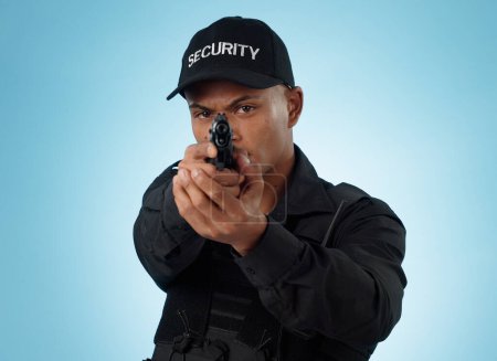 Photo for Man, security guard and pointing gun for shooting, protection and hands with face, portrait or confident. Target, safety or weapon for criminal, aim or studio background for pistol, crime or arrest. - Royalty Free Image