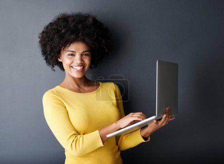 Photo for E learning, work and portrait of black woman with laptop, mockup and happiness in studio background. Computer, research and college student typing on keyboard for working, project or online class. - Royalty Free Image