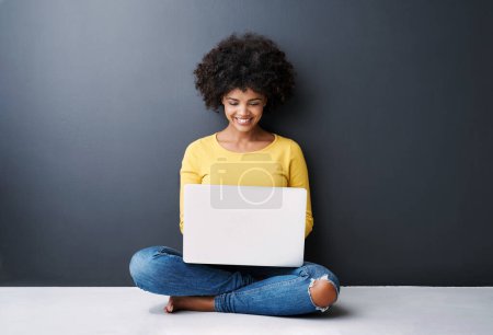 Photo for Remote work, online and black woman with laptop in studio with happiness for education or class. Computer, research and college student typing on keyboard for elearning, project or studying in home. - Royalty Free Image