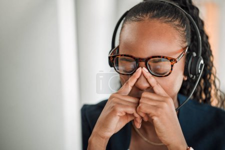 Photo for Call center stress, eye strain or black woman with headache pain due to burnout fatigue in a telecom office. Anxiety, glasses or tired consultant depressed or frustrated by long hours or migraine. - Royalty Free Image