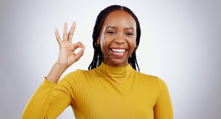 Photo for Portrait, smile and black woman with perfect hand in studio for feedback, support or motivation on grey background. Ok, emoji and face of lady model with vote success, thank you or review excellence. - Royalty Free Image