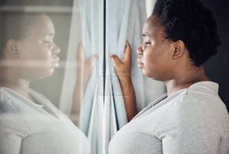 Photo for Window, thinking or black woman with depression, stress or mental health crisis by curtain at home. Worry, lonely lady or sad African person with broken heart, loss or anxiety from emotional grief. - Royalty Free Image