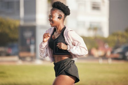 Photo for Black woman, smile and running outdoor with music earphones for listening to radio or podcast. Fitness, sports and happy African athlete training, workout and exercise for health, wellness or cardio. - Royalty Free Image