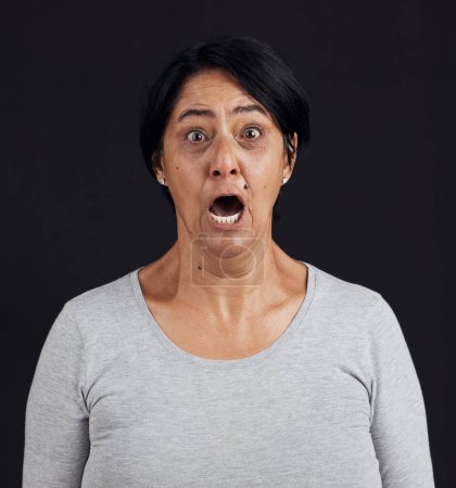 Photo for Portrait, screaming and senior woman with fear, shocked and news with mental health, scared and stress, Face, elderly lady and mature model with emoji, afraid and retirement on dark studio background. - Royalty Free Image