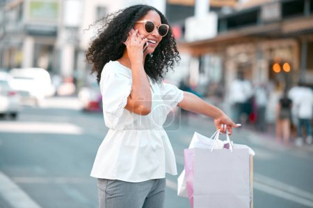 Photo for Taxi request, shopping bags and woman with phone call in the city standing in the street. Girl smile with gifts, 5g mobile in hand or smartphone in London road travel happy from sale or discount. - Royalty Free Image