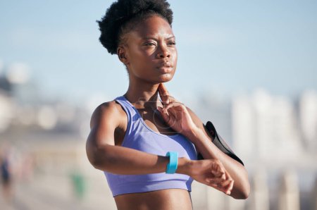 Photo for Sports, workout and woman checking pulse for body wellness with smartwatch for running outdoor. Fitness, exercise and healthy African female athlete monitoring heart rate for cardio training for race. - Royalty Free Image