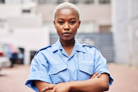 Photo for Portrait, black woman and security guard with arms crossed for surveillance service, safety and urban watch. Law enforcement, bodyguard or serious female police officer in blue shirt for city patrol. - Royalty Free Image