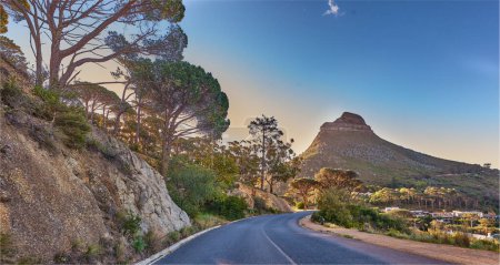 Photo for An empty road on the mountain at sunrise. Street overlooking mountain peak with a scenic view of the city from a street on the mountain at sunset. The landscape of a beautiful view of Lions head. - Royalty Free Image