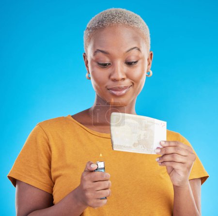 Photo for Burning, money and woman with euro bills on fire, flame or college student with debt in financial crisis on blue background. Inflation, increase or African customer spending credit with interest rate. - Royalty Free Image