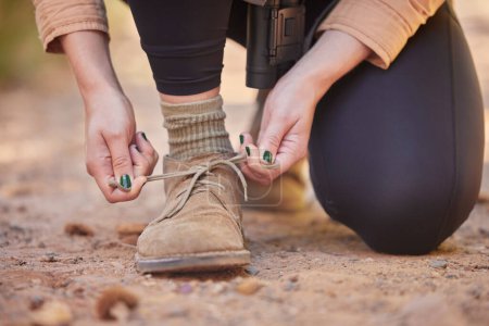 Photo for Shoes, hiking and woman tying laces to start a walk, adventure or trekking in nature of Norway. Ready, active and feet and hands of a girl walking on ground in the mountains for exercise and cardio. - Royalty Free Image