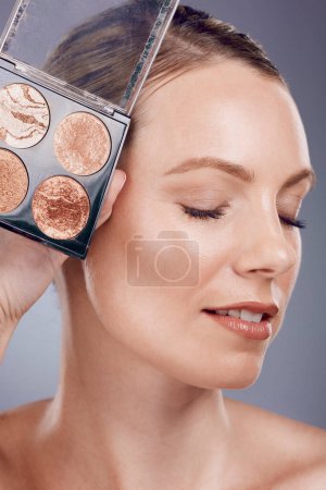 Photo for Makeup pallet, woman and face with cosmetics product for beauty, foundation and eye powder on studio background. Cosmetic care and cosmetology, eyeshadow or blush, lashes and advertising. - Royalty Free Image