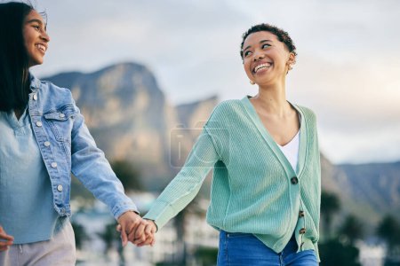 Photo for Travel, gay couple and women friends outdoor with trust, freedom and pride on travel. LGBTQ or lesbian people holding hands for walk, romantic date and commitment to happy partner in South Africa. - Royalty Free Image