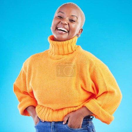 Photo for Studio, portrait and happy African woman with fashion, natural beauty and confidence in casual style or clothes on blue background. Face, smile and happiness in winter clothing or college student. - Royalty Free Image