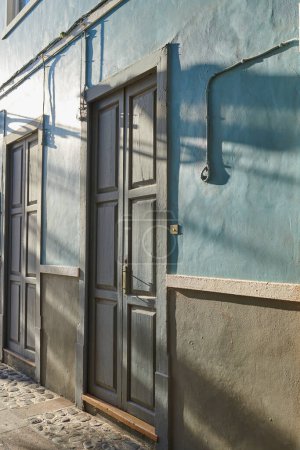 Photo for Historic Spanish architecture outdoors of a building in a overseas. Backdoor of a home or residential building. Two old blue doors to a traditional house outside in Santa Cruz de La Palma, Spain - Royalty Free Image