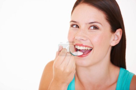 Photo for Eating, yogurt and portrait of woman with healthy food, diet or nutrition in studio with happiness. Happy, face and girl with spoon, yoghurt and strawberry flavor of dairy, product or snack for lunch. - Royalty Free Image