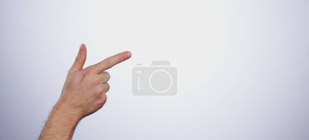 Photo for Hand, pointing and person in studio with mockup space for advertising, promotion or marketing. Finger, closeup and man model with show or presentation gesture for empty mock up by white background - Royalty Free Image