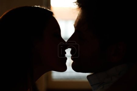 Photo for Home, silhouette and couple with love, marriage and shadow with profile, relationship and romance. People, man and woman with kissing, bonding together and support with care, date and romantic. - Royalty Free Image