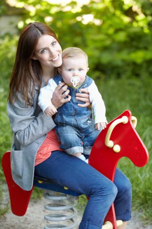Photo for Portrait, mother and baby with toy, horse and park for fun in bond by playing for outside together. Happy woman, infant or smile for milestone, future growth or development with love, support or care. - Royalty Free Image