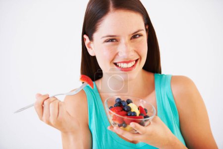Photo for Health, happy and portrait of woman with fruit salad eating for nutrition, wellness and berry snack in studio. Food, diet and face of person for vitamins, detox and lose weight on white background. - Royalty Free Image