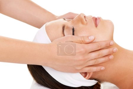 Face, hands and facial massage with a woman customer in studio isolated on a white background for stress relief. Spa, luxury treatment and a young person at the salon for health, wellness or to relax.