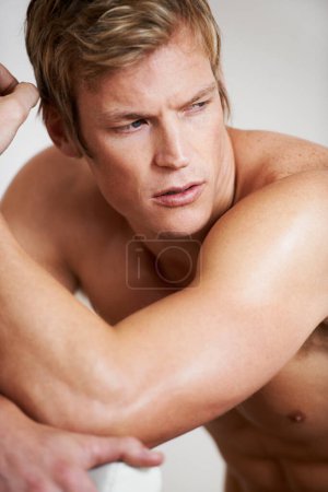 Photo for Man, shirtless and muscle in studio or white background for confident masculine, strong body or bodybuilder pride. Male person, model and topless for bicep arms or shoulders, attractive in Norway. - Royalty Free Image