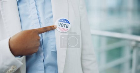 Photo for Hand, sticker and vote for president election or cast ballot, poll station for government selection. Black person, finger pointing and badge for politics decision support, patriotic or usa opinion. - Royalty Free Image