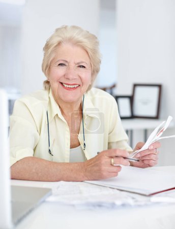 Photo for Portrait, smile and old woman with budget documents, savings and taxes in home. Financial planning, face and retirement of senior female person with paper for pension, investment or finance bills - Royalty Free Image