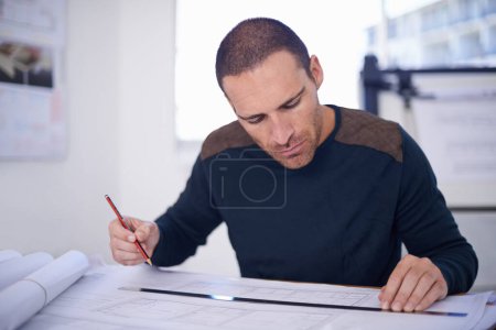 Photo for Focused to ensure perfection. an architect drafting up building plans - Royalty Free Image