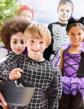 Photo for Trick-or-treating cuties. Portrait of happy little children trick-or-treating on halloween - Royalty Free Image