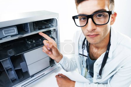 Photo for Computer technician, man and pointing at tech hardware, electronics or machine internal problem, fail or risk. Appliance maintenance, serious studio portrait or IT support gesture on white background. - Royalty Free Image