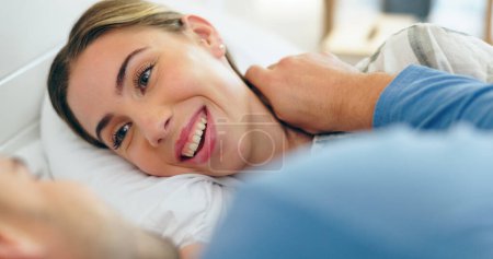Photo for Face, smile and a young couple in bed together to relax or wake up in the morning of a weekend. Trust, romance or happy with a man and woman partner closeup in the bedroom of their home for love. - Royalty Free Image