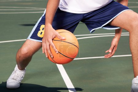Photo for Man, legs and basketball on court for playing, training or workout with performance and wellness. Athlete, person or ball for sport, exercise or technique with fitness, skill and sports match outdoor. - Royalty Free Image