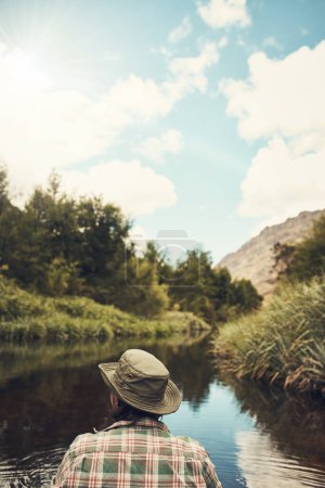 Photo for Get out there and explore the great outdoors. Rearview shot of a young man going for a canoe ride on the lake - Royalty Free Image