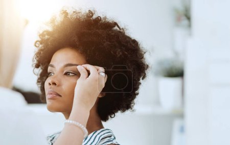 Photo for Woman, beauty and face with makeup artist for eyeshadow, blush or foundation by hand. Black model, hair or afro with determined, expression or look for application of cosmetic product with lens flare. - Royalty Free Image