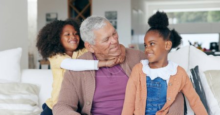 Photo for Happy, hug and grandfather on sofa with children for bonding, relationship and relax at home. Family, love and young girls embrace grandpa for trust, care and affection in living room on weekend. - Royalty Free Image
