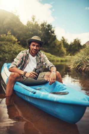 Photo for You should join me on the next adventure. Portrait of a young man going for a canoe ride on the lake - Royalty Free Image