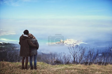 Photo for Taking in the view. Rearview shot of an affectionate young couple enjoying a hike in the mountains - Royalty Free Image