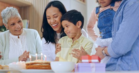 Photo for Child with birthday cake, candles and big family to celebrate with smile, fun and love together in home. Happiness, gift and congratulations, mom and grandparents at kids party with excited children - Royalty Free Image