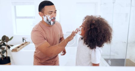 Photo for Shaving, foam and father with son in bathroom for skincare, wellness and hygiene at home together. Family, beauty and happy dad teaching child with soap, cream and shave for cleaning or grooming. - Royalty Free Image