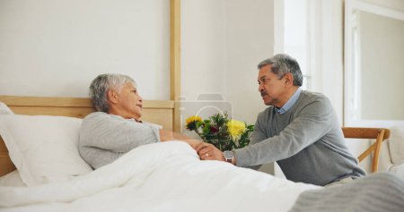 Photo for Wife, bedroom and man sick support for concern comfort or disease illness, virus infection or injury. Woman, husband and hand holding in home for health wellness fear or risk healing, couple as sad. - Royalty Free Image