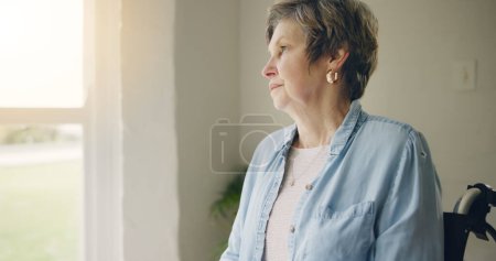 Photo for Wheelchair, elderly woman or thinking of memory by window in nursing home or retirement with depression. Grief nostalgia, sad history or lonely senior person in living room to remember past loss. - Royalty Free Image