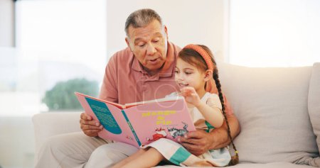 Photo for Grandpa, child and reading book on sofa for literature, education or bonding together at home. Grandparent with little girl or kid smile for story, learning or relax on living room couch at house. - Royalty Free Image