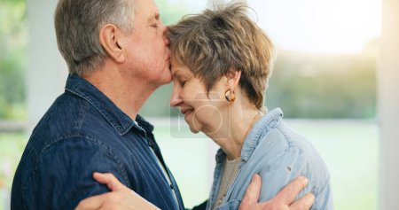 Photo for Senior couple, forehead or kiss of love in support, loyalty or commitment in retirement in family home. Mature man, woman or marriage in gratitude for together in trust, security or care in apartment. - Royalty Free Image