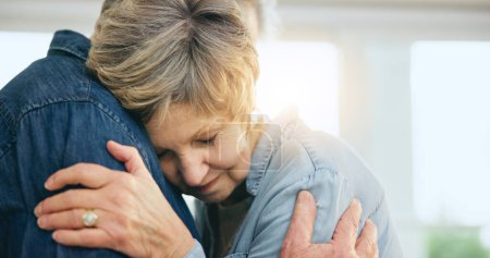 Photo for Senior couple, hug or support in home for love, loyalty or bonding together in retirement in marriage commitment. Mature man, woman or embrace for gratitude, wellness or comfort peace in family house. - Royalty Free Image