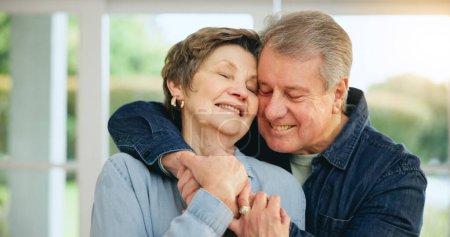 Photo for Senior couple, hug and smile at home for love, loyalty and retirement bliss in marriage commitment. Mature man, woman or embrace for gratitude in together, peace wellness and kindness in family house. - Royalty Free Image