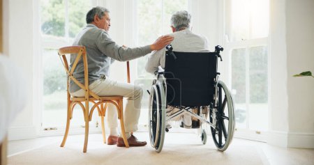 Photo for Elderly man, comfort and woman in wheelchair, touch and support partner in retirement with love. Senior couple, care and hand for together in marriage, sickness and health for wellness in family home. - Royalty Free Image