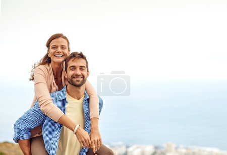 Photo for Couple, piggy back and smile in portrait, outdoors and vacation or holiday, date and bonding for love. Happy people, play and fun on trip, travel and connection in marriage, support and trust or face. - Royalty Free Image