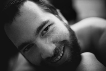 Photo for Portrait, smile and man in home, monochrome and relax in living room of apartment or house. Happy face of young person on black and white, dark and confident student on profile picture in Spain. - Royalty Free Image