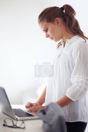 Photo for College student, reading and morning in home with laptop, online communication and check email. Computer, remote work and woman typing on keyboard or planning schedule, education and elearning. - Royalty Free Image