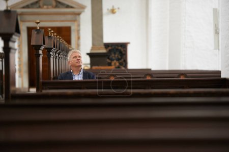 Photo for Senior man, sitting and church for religion, faith or pray at cathedral or holy grounds in Jesus Christ. Mature or religious male person looking up in sanctuary for salvation, forgiveness or worship. - Royalty Free Image